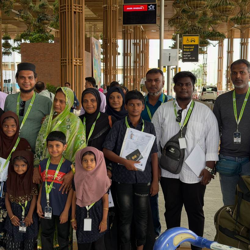 A family wearing their Talbiyah lanyards at the airport before departure.