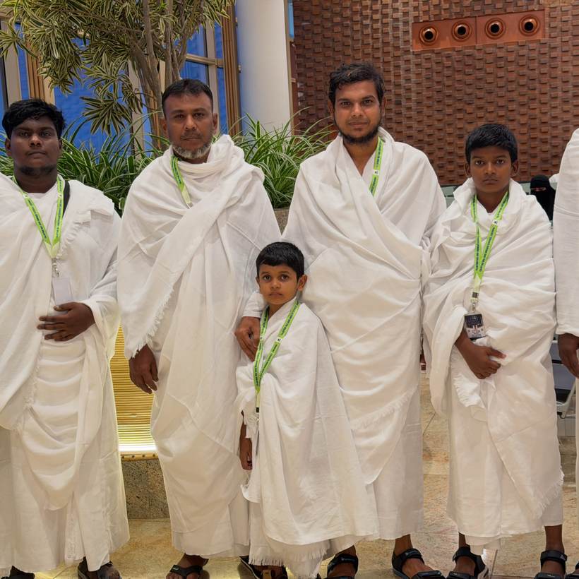 A father and his sons in ihram, waiting to travel on to Makkah.